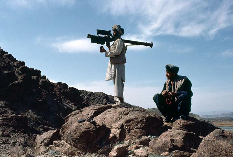 A Mujahideen fighter aims an FIM-92 Stinger missile at passing aircraft, Afghanistan, 1988 2.jpg